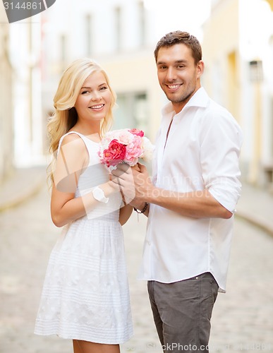 Image of couple with flowers in the city