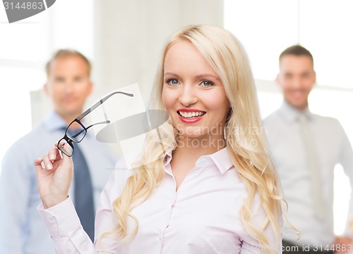 Image of smiling businesswoman or secretary in office