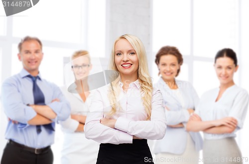 Image of smiling businesswoman or secretary in office