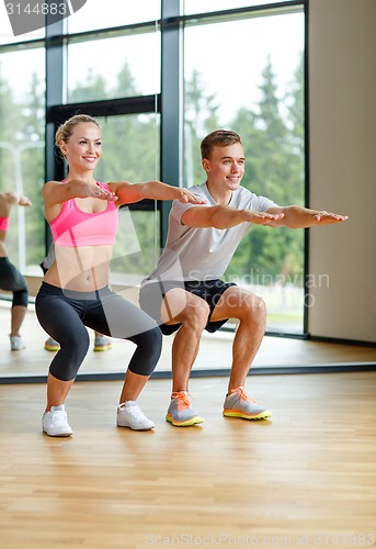 Image of smiling man and woman in gym