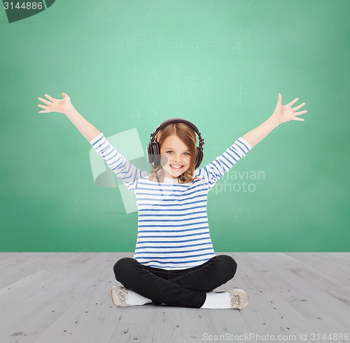 Image of happy girl with headphones listening to music