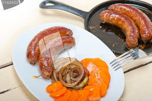 Image of beef sausages cooked on iron skillet 