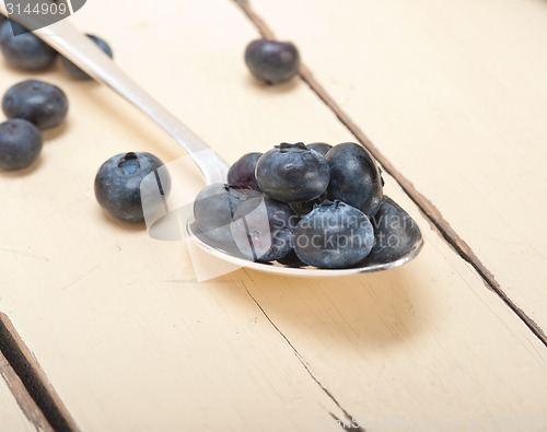 Image of fresh blueberry on silver spoon