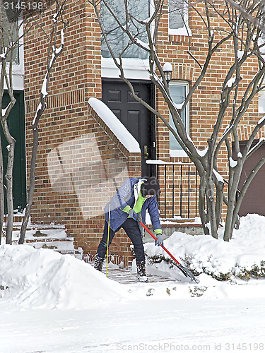Image of Person clearing snow