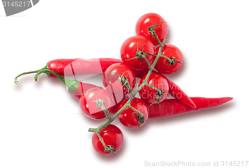 Image of Branch of cherry tomatoes and two red chili peppers