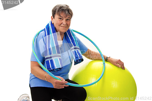Image of Senior woman with fitness ball and hula-hoop