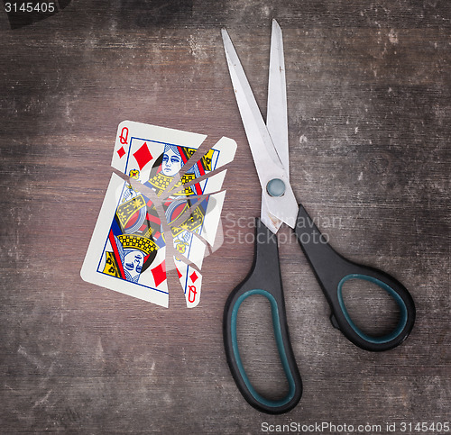 Image of Concept of addiction, card with scissors