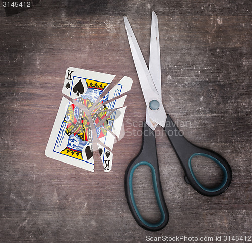 Image of Concept of addiction, card with scissors