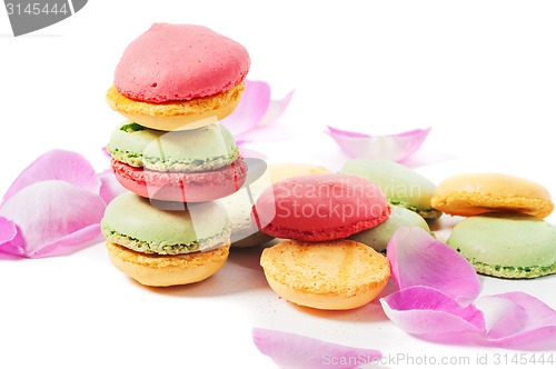 Image of Macaron cookies and pink rose petals 