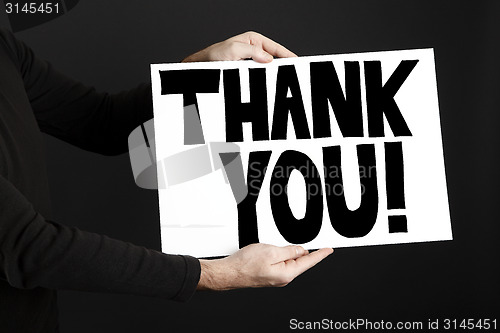 Image of Man holding poster with thank you