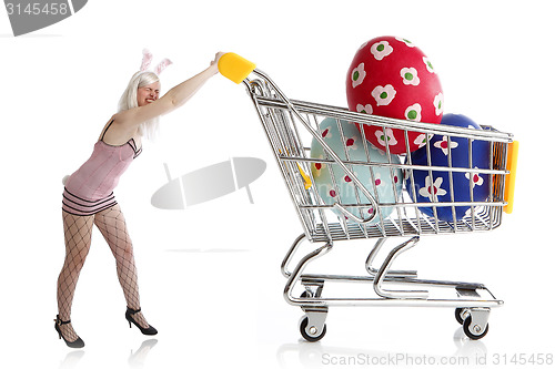 Image of Easter bunny with colorful eggs in her shopping cart