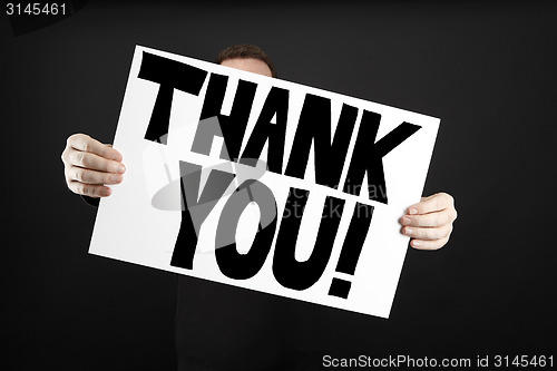 Image of Man holding poster with thank you