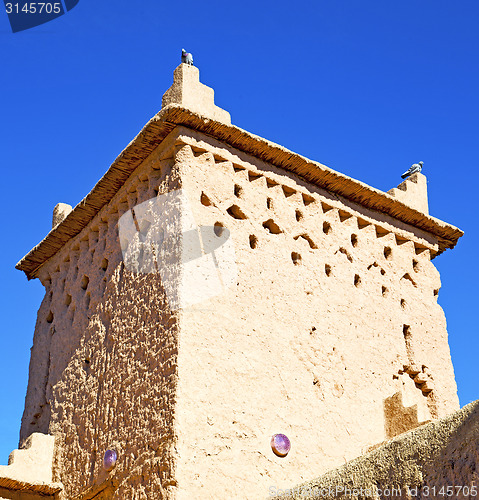 Image of brown old  construction in  africa morocco and  clouds  near the