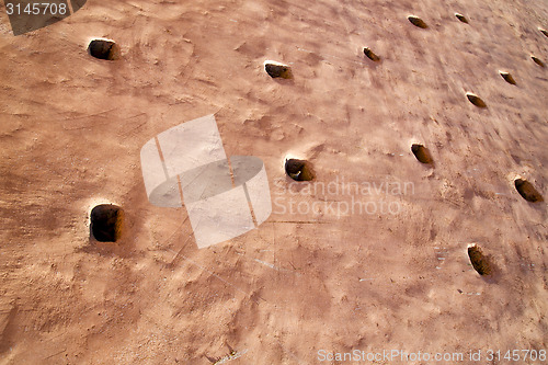 Image of brown hole  in texture wall  morocco africa abstract