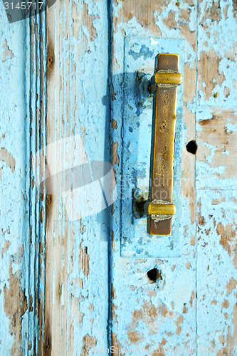 Image of rusty metal nail dirty stripped paint in the blue  