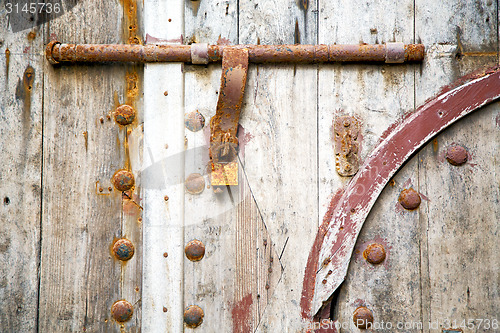 Image of brown  morocco in  the old wood    rusty safe padlock 