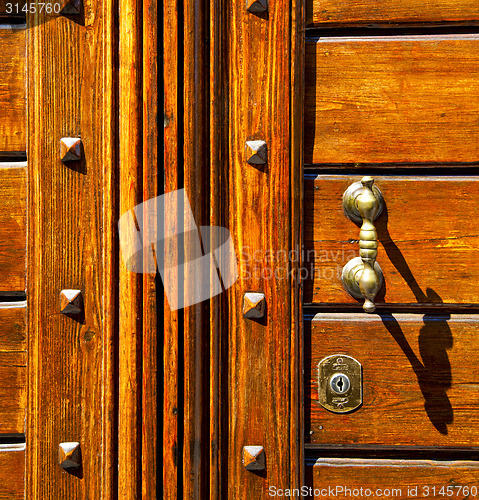 Image of abstract  rusty brass brown knocker olgiate olona varese italy