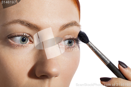 Image of Pretty Woman Applying Eye Shadow Makeup