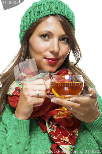 Image of Attractive woman warming up with a cup of hot tea