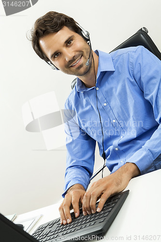 Image of Man wearing headset giving online chat and support