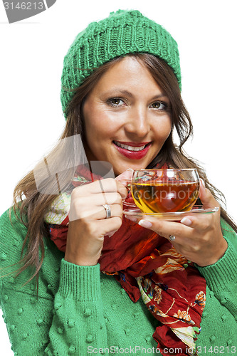 Image of Attractive woman warming up with a cup of hot tea