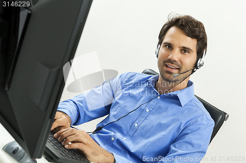 Image of Man wearing headset giving online chat and support