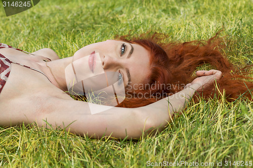 Image of Happy Woman Lying on Grassy Ground