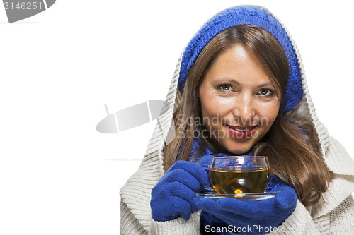 Image of Fashionable young woman sipping hot tea