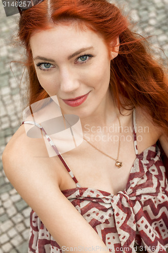 Image of Pretty Blond Woman Sitting on Red Chair