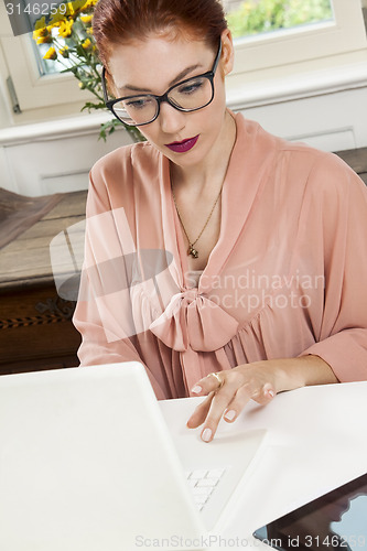 Image of Young Businesswoman Looking at Computer Seriously
