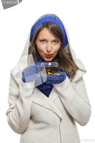 Image of Fashionable young woman sipping hot tea