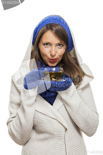 Image of Fashionable young woman sipping hot tea