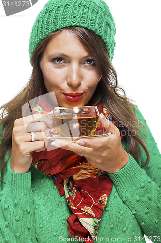 Image of Attractive woman warming up with a cup of hot tea