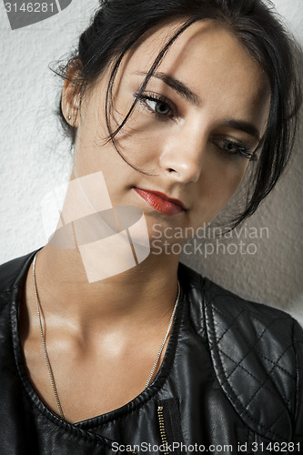 Image of Woman in Black Leather Jacket Holding her Hair