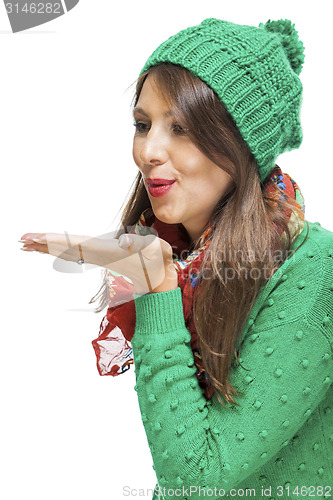 Image of Romantic young woman blowing a kiss