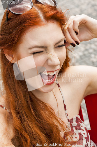 Image of Pretty Blond Woman Sitting on Red Chair