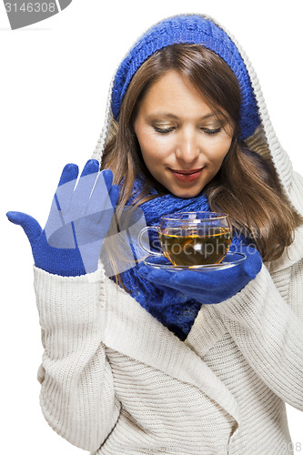 Image of Fashionable young woman sipping hot tea