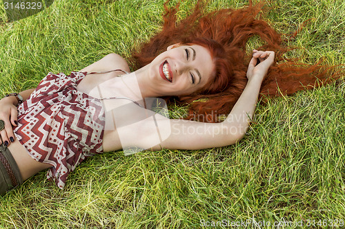 Image of Happy Woman Lying on Grassy Ground