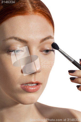 Image of Pretty Woman Applying Eye Shadow Makeup