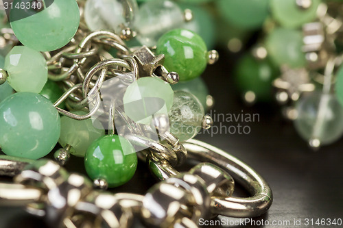 Image of Green beads on an item of silver jewellery