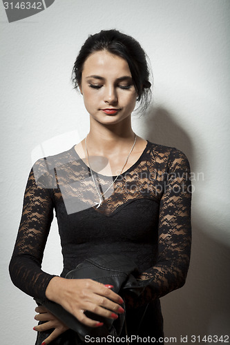 Image of Gorgeous Woman in Black Dress Carrying her Jacket