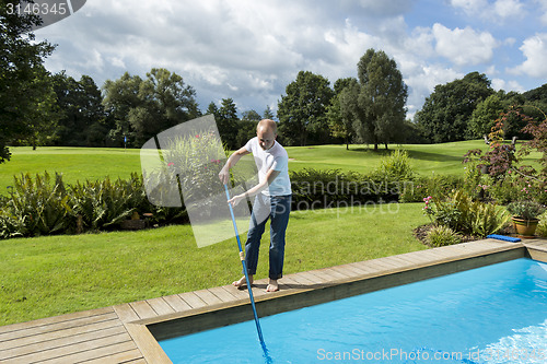 Image of Man Cleaning Swimming Pool