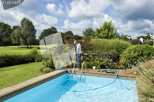 Image of Man Cleaning Swimming Pool