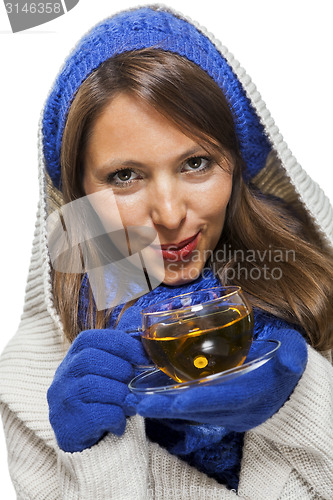 Image of Fashionable young woman sipping hot tea