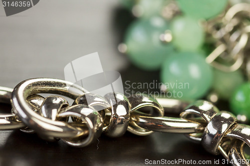 Image of Green beads on an item of silver jewellery