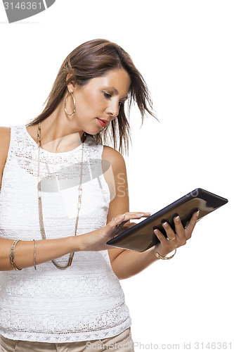 Image of Woman chatting on a mobile while reading a tablet