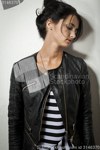 Image of Woman in Black Leather Jacket Holding her Hair