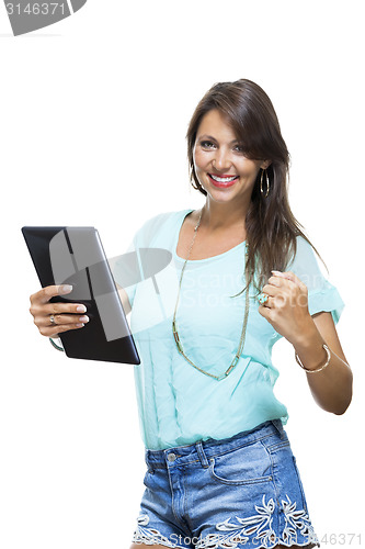 Image of Pretty Woman Browsing at her Tablet Computer