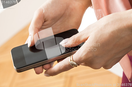 Image of Serious Office Woman Looking at her Mobile Phone