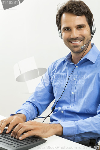 Image of Man wearing headset giving online chat and support